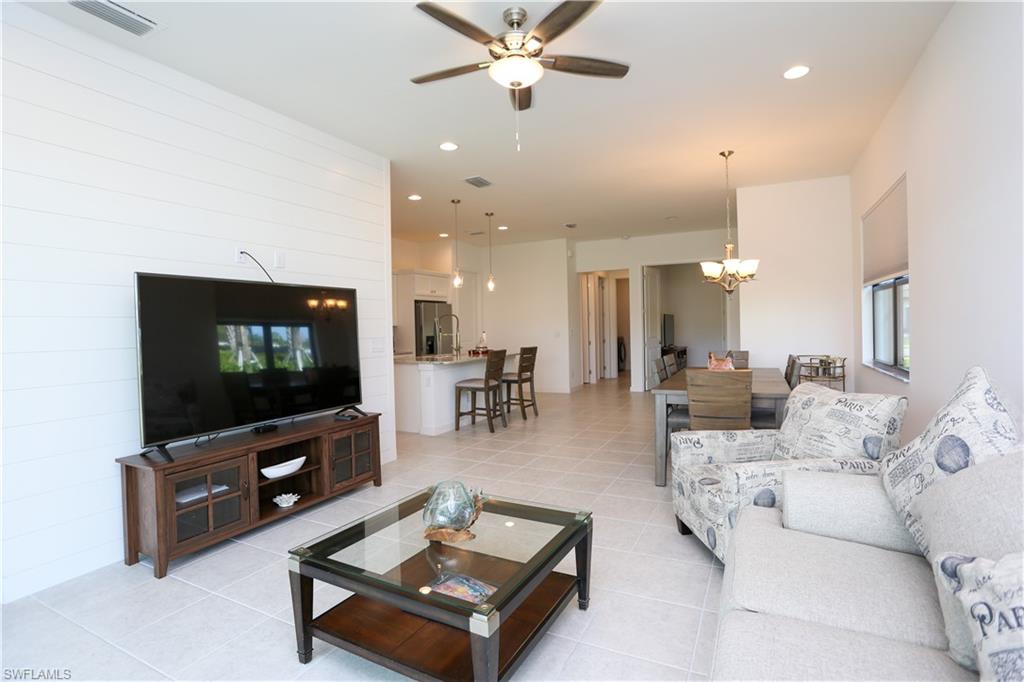 14759 Kingfisher Loop Naples, FL 34120 - Photo 5 of 35 a living room with furniture and a flat screen tv