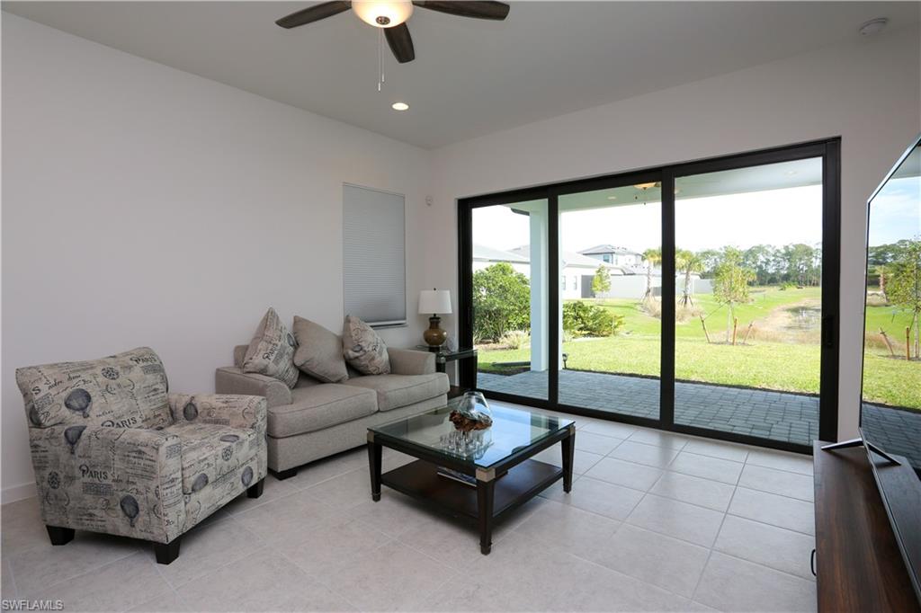 14759 Kingfisher Loop Naples, FL 34120 - Photo 7 of 35 a living room with furniture and a floor to ceiling window