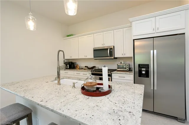a kitchen with a refrigerator a stove a sink and a wooden cabinets