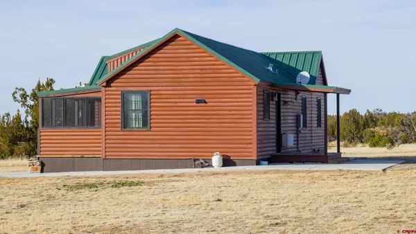 a view of a house with wooden fence