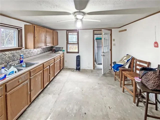 a large kitchen with kitchen island white cabinets and stainless steel appliances