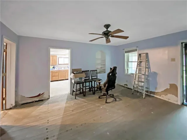 a view of a livingroom with workspace and a window