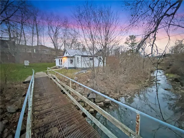 a view of a pathway with a wrought fence
