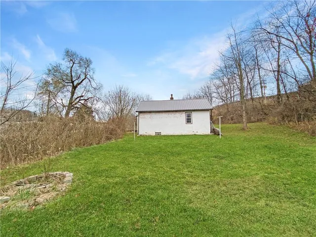 a view of a backyard with large trees