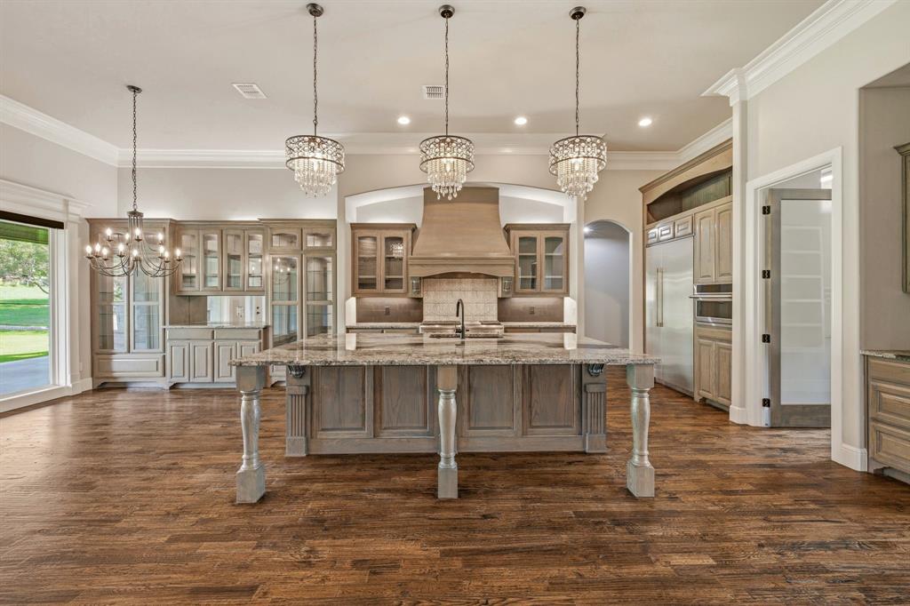 9503 Bellechase Road Granbury, TX 76049 - Photo 8 of 40 a view of dining room and kitchen with granite countertop wooden floor