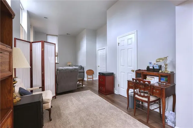 a bathroom with a granite countertop sink a toilet and mirror
