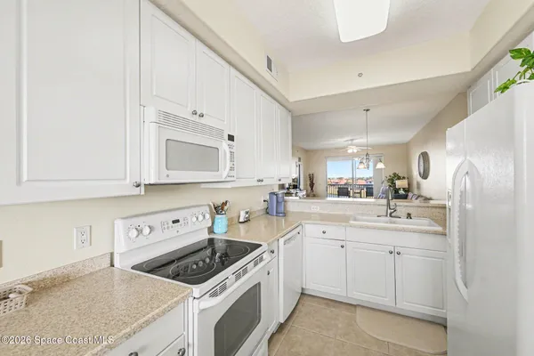 a living room with furniture and a red cabinet
