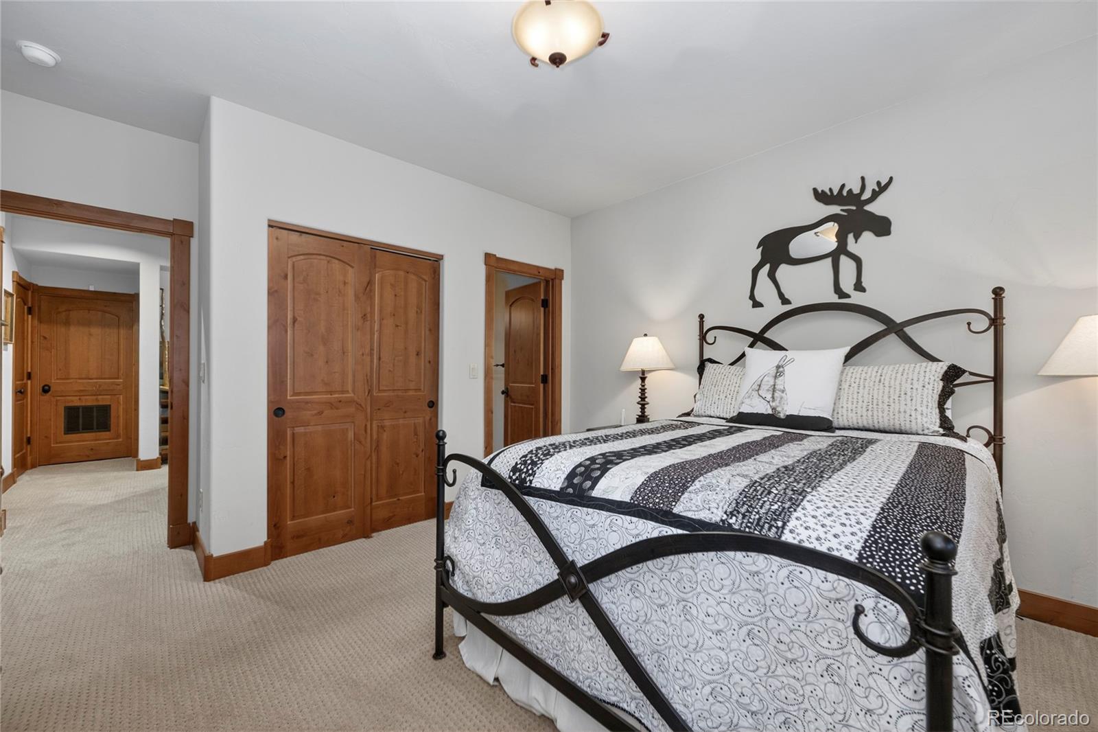 148 County Road Tabernash, CO 80478 - Photo 21 of 45 a bedroom with a bed and chandelier