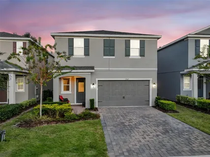 a front view of a house with a garden and garage