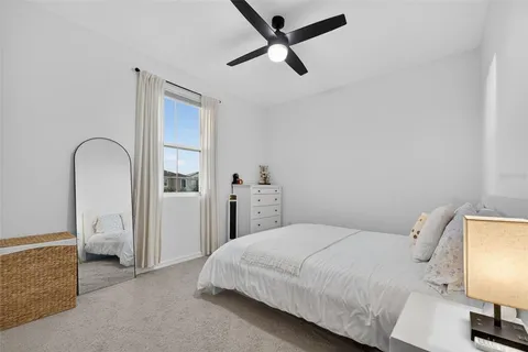 a bedroom with a bed and a lamp