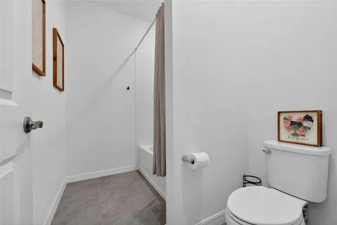 a white toilet sitting next to a bathroom sink