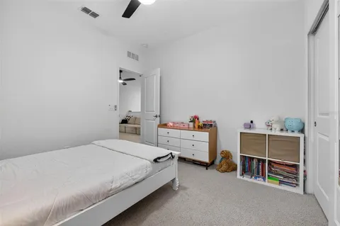 a bedroom with a bed and a desk