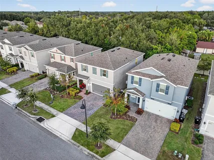 an aerial view of multiple houses with a yard