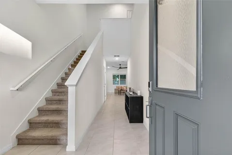 a view of entryway and hall with wooden floor