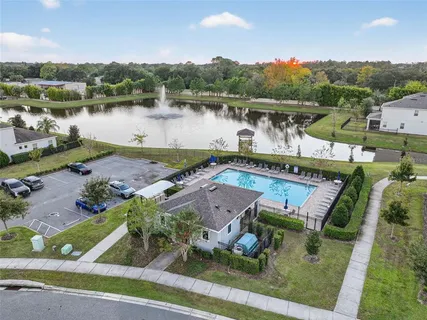 an aerial view of a house with pool lake view and mountain view