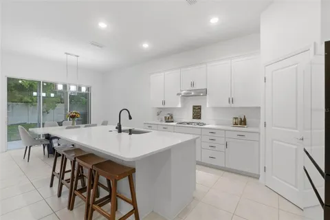 a kitchen with sink and white cabinets