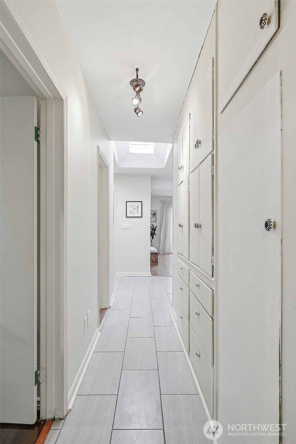17633 10th Avenue Northeast Shoreline, WA 98155 - Photo 21 of 33 a hallway with white doors and chandelier