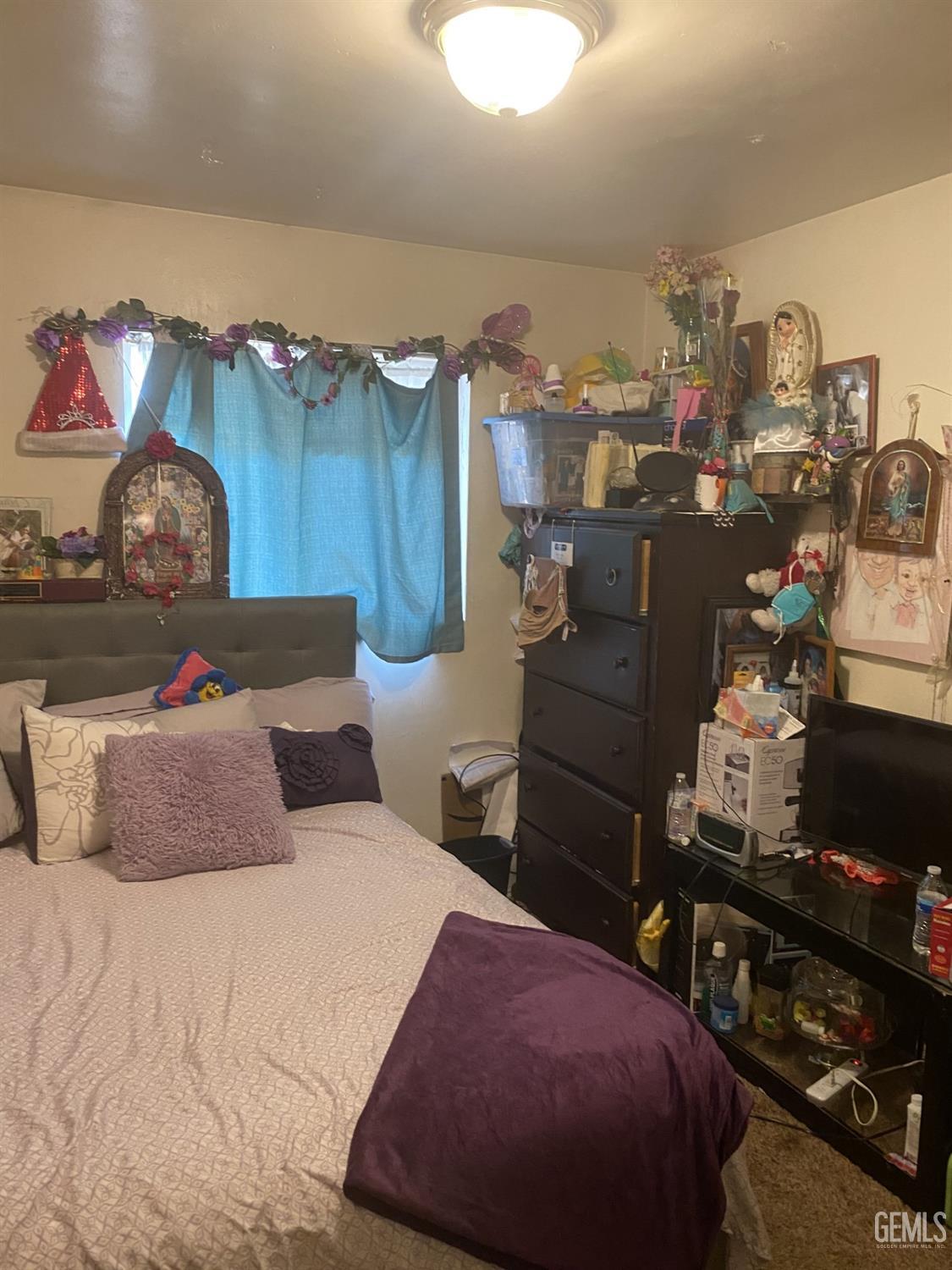 Undisclosed Address Bakersfield, CA 93306 - Photo 10 of 20 a bedroom with a bed and a night stand