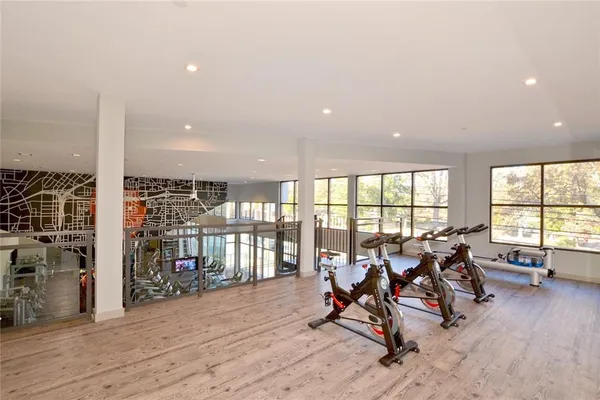 a view of a room with gym equipment and large window