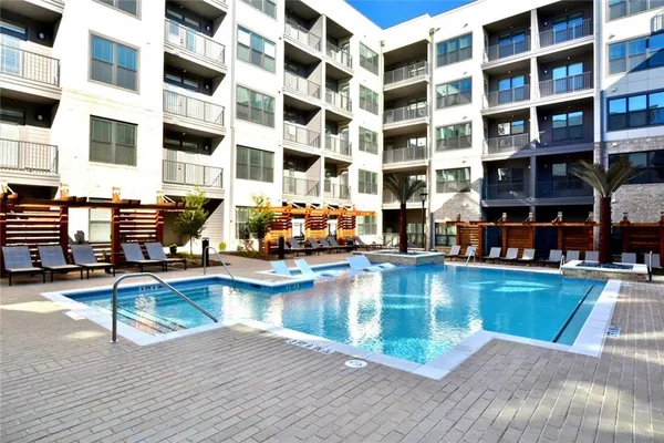 a view of a swimming pool with outdoor seating