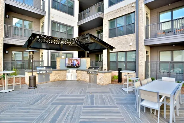 a view of a patio with dining table and chairs with wooden floor