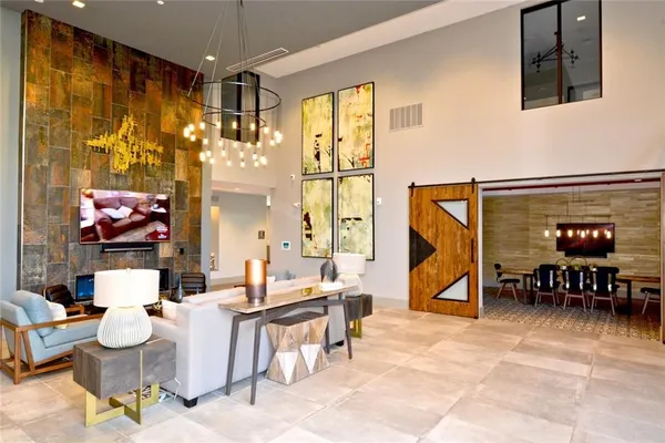 a living room with fireplace furniture and a large window