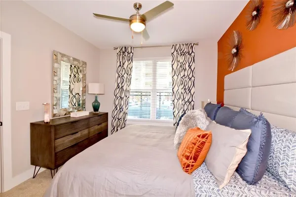 a bedroom with a large bed and a window