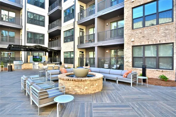 a view of a patio with couches table and chairs and wooden floor