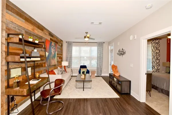 a living room with furniture and wooden floor