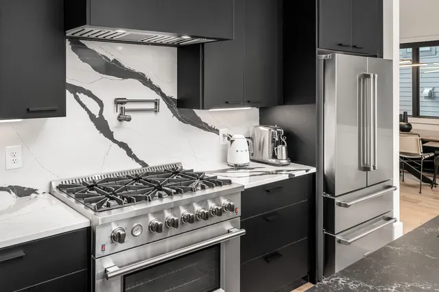a kitchen with a stove and a refrigerator