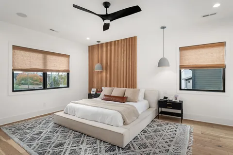 a bedroom with a bed couch and window