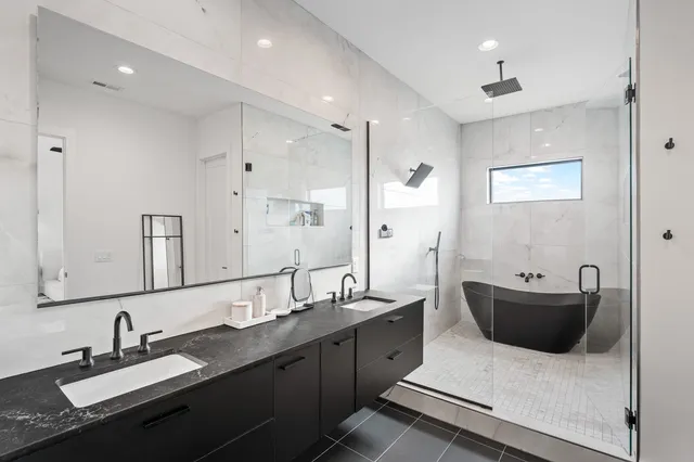 a bathroom with double sink and a mirror