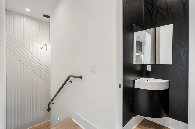 a bathroom with a toilet sink and mirror