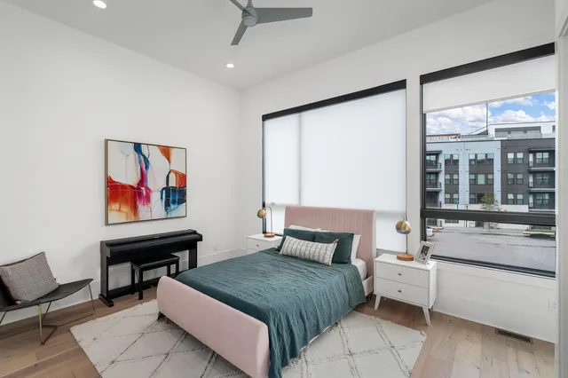 a bedroom with a bed and wooden floor