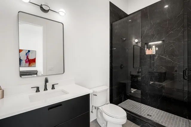 a bedroom with a bed and a couch