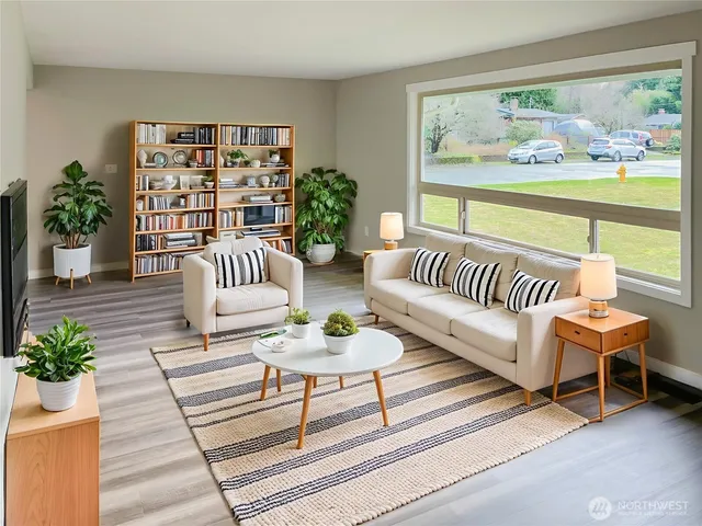 a living room with furniture and a potted plant