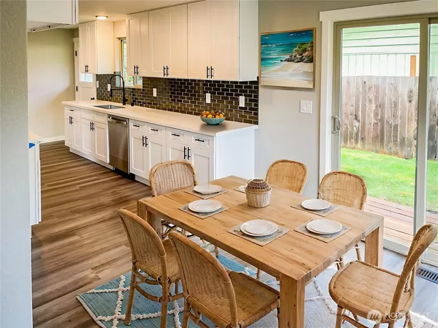 a kitchen with a table chairs stove and kitchen view
