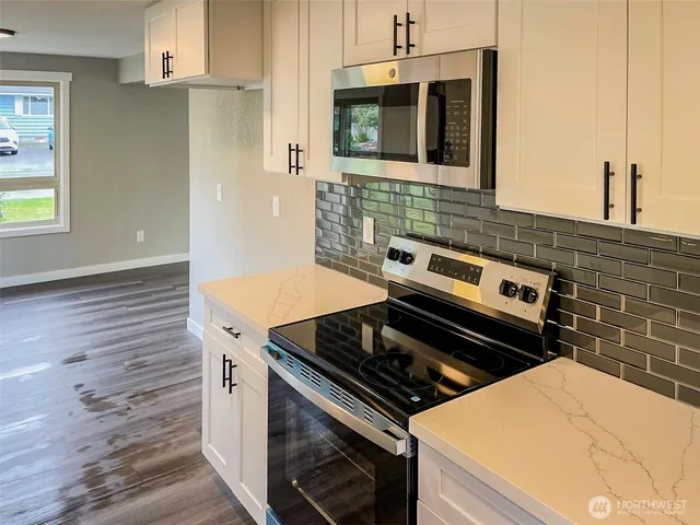 a stove top oven sitting inside of a kitchen