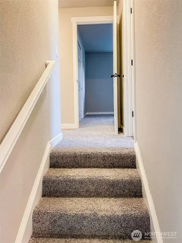 a view of staircase with white walls