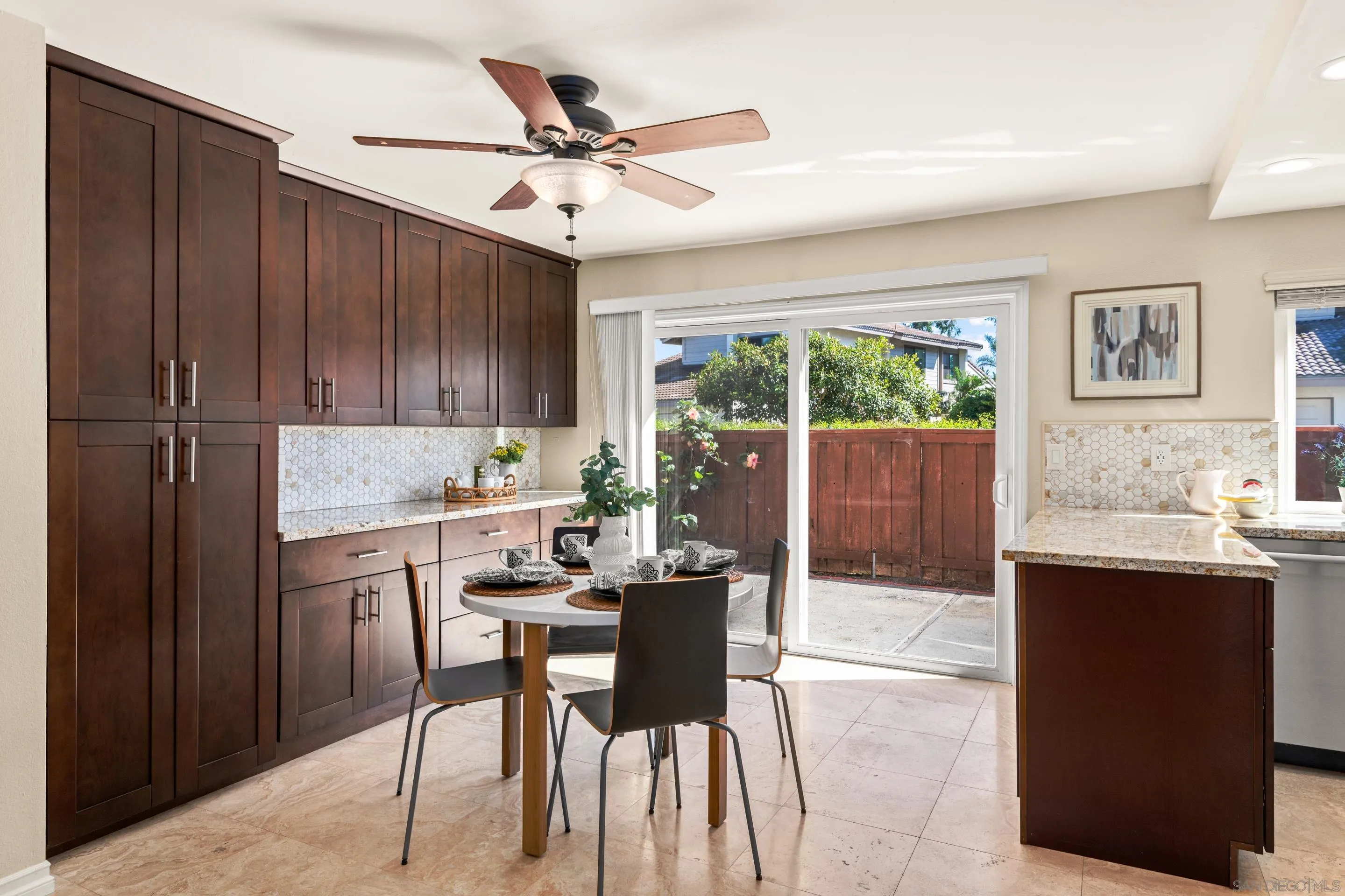 2002 Leafwood Place Encinitas, CA 92024 - Photo 12 of 64 a kitchen with a dining table chairs and cabinets