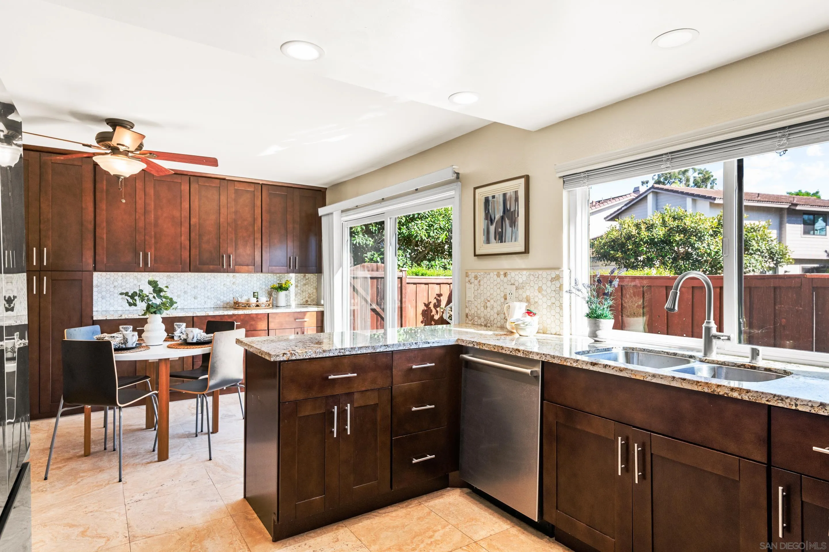 2002 Leafwood Place Encinitas, CA 92024 - Photo 16 of 64 a kitchen with a sink window and chairs