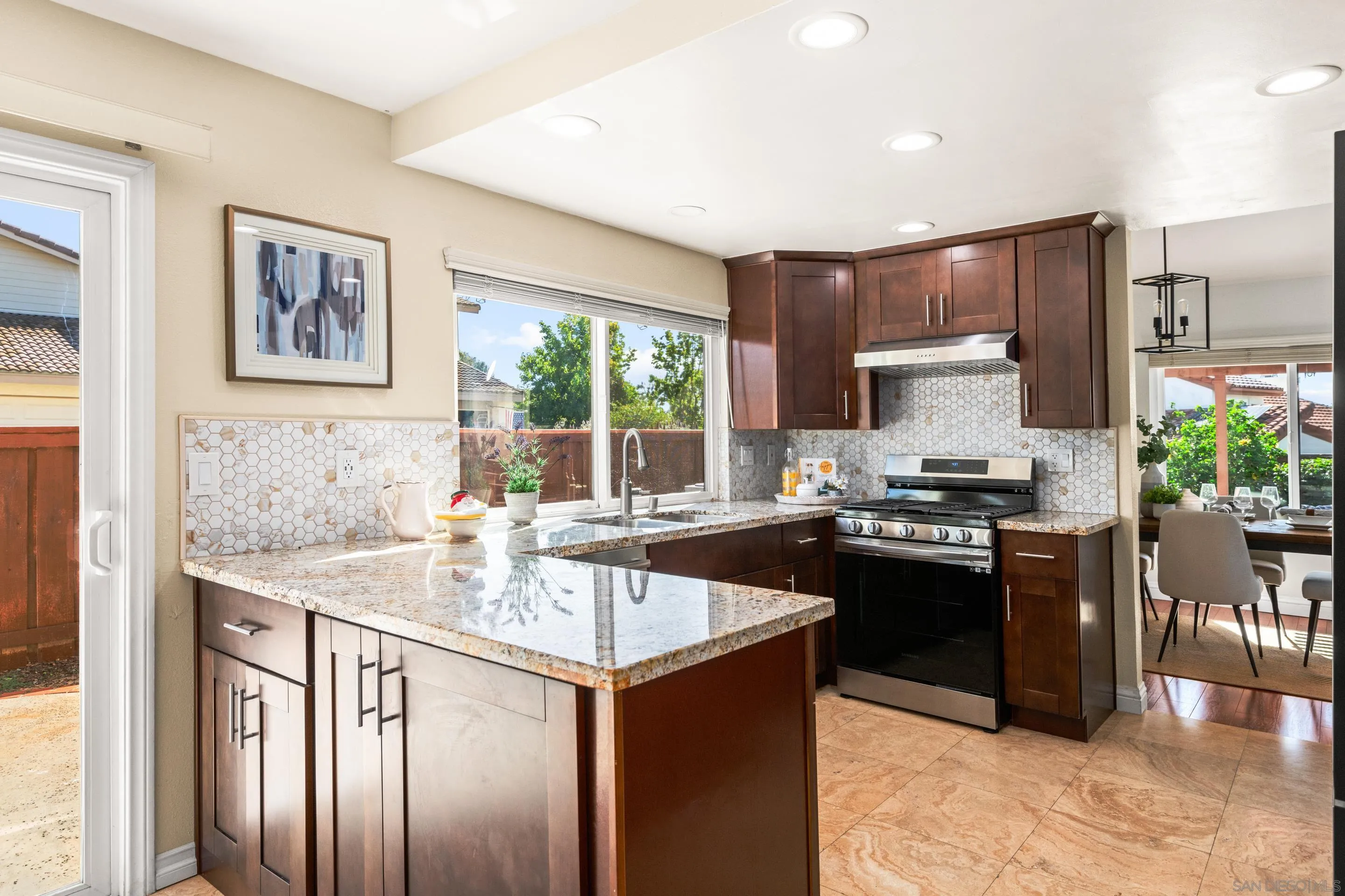 2002 Leafwood Place Encinitas, CA 92024 - Photo 17 of 64 a kitchen with stainless steel appliances granite countertop a stove a sink and a refrigerator