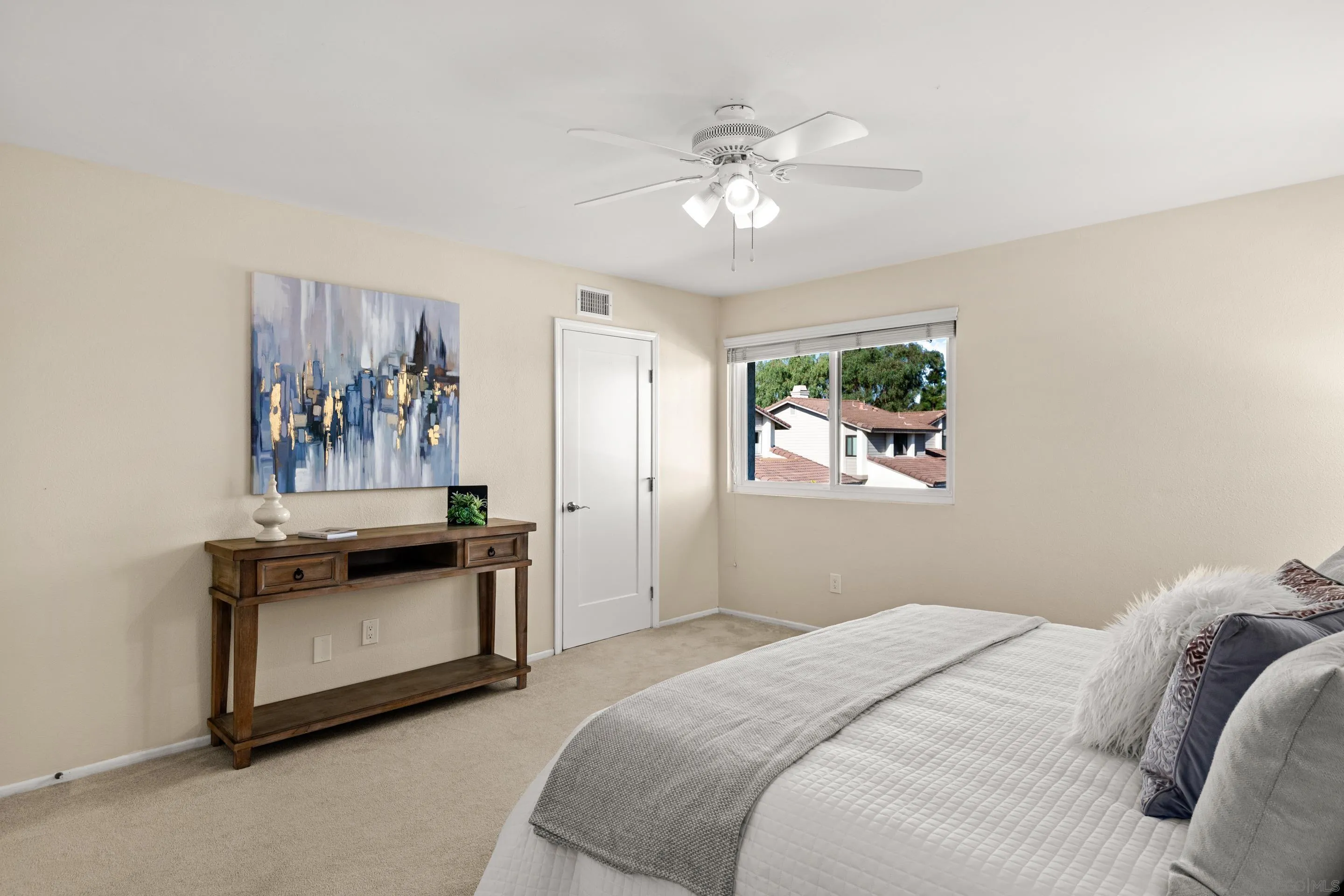 2002 Leafwood Place Encinitas, CA 92024 - Photo 21 of 64 a bedroom with a bed and a chandelier