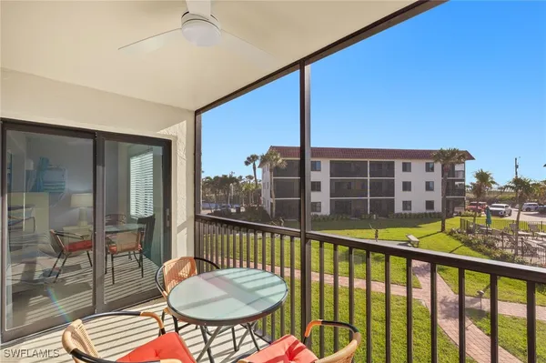 a balcony with table and chairs