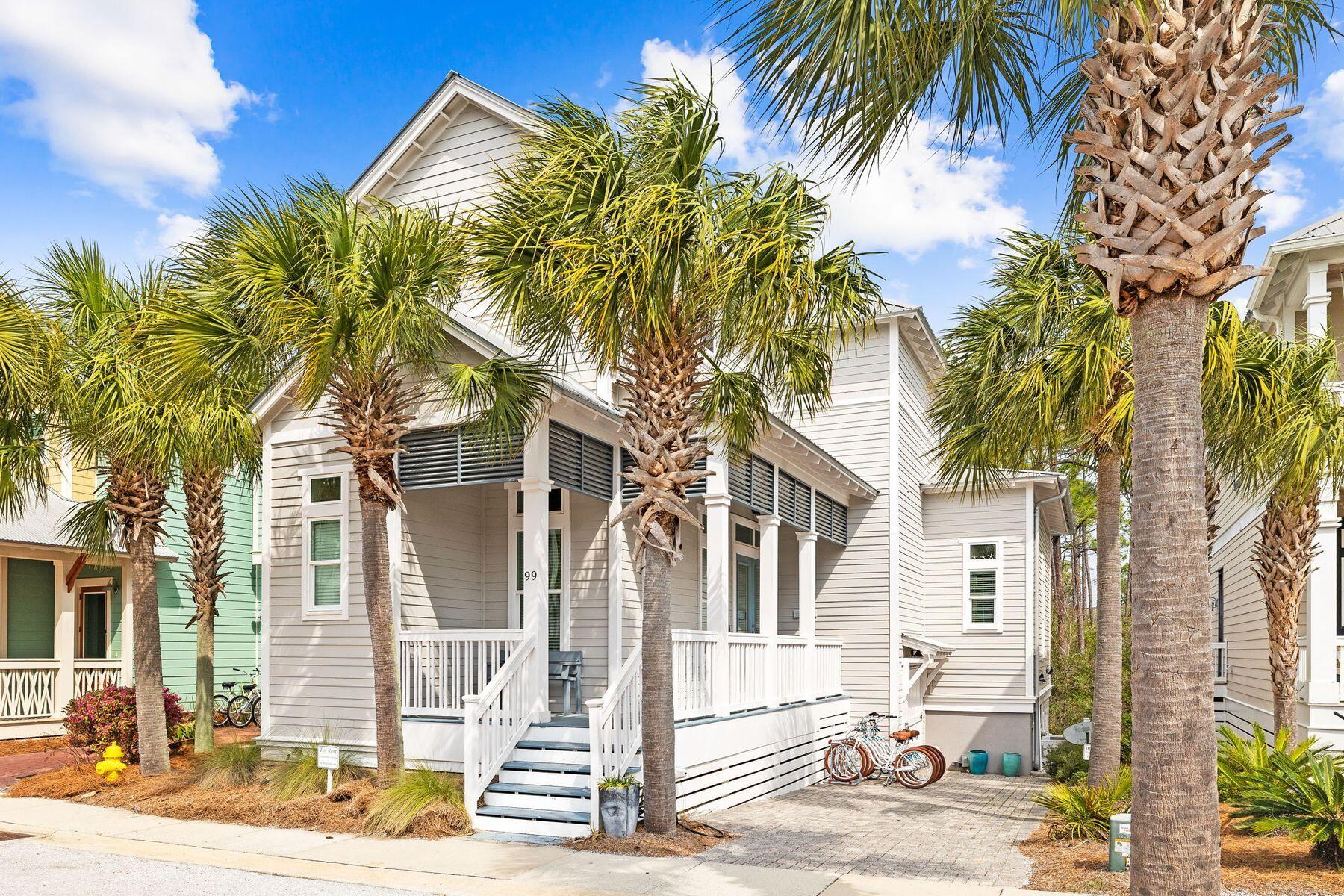 a front view of a house with a tree