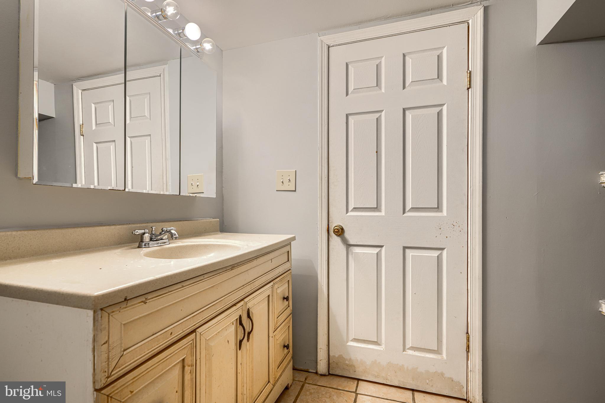 9706 Liberty Road Randallstown, MD 21133 - Photo 43 of 43 a bathroom with a sink a vanity and a mirror