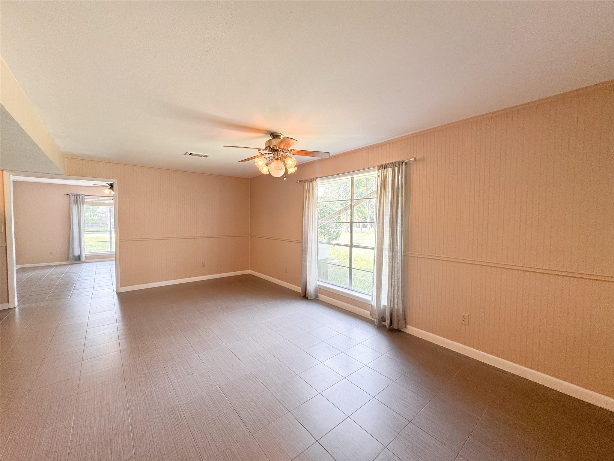 15331 Lake Lamond Road Conroe, TX 77384 - Photo 12 of 29 wooden floor in an empty room with a window
