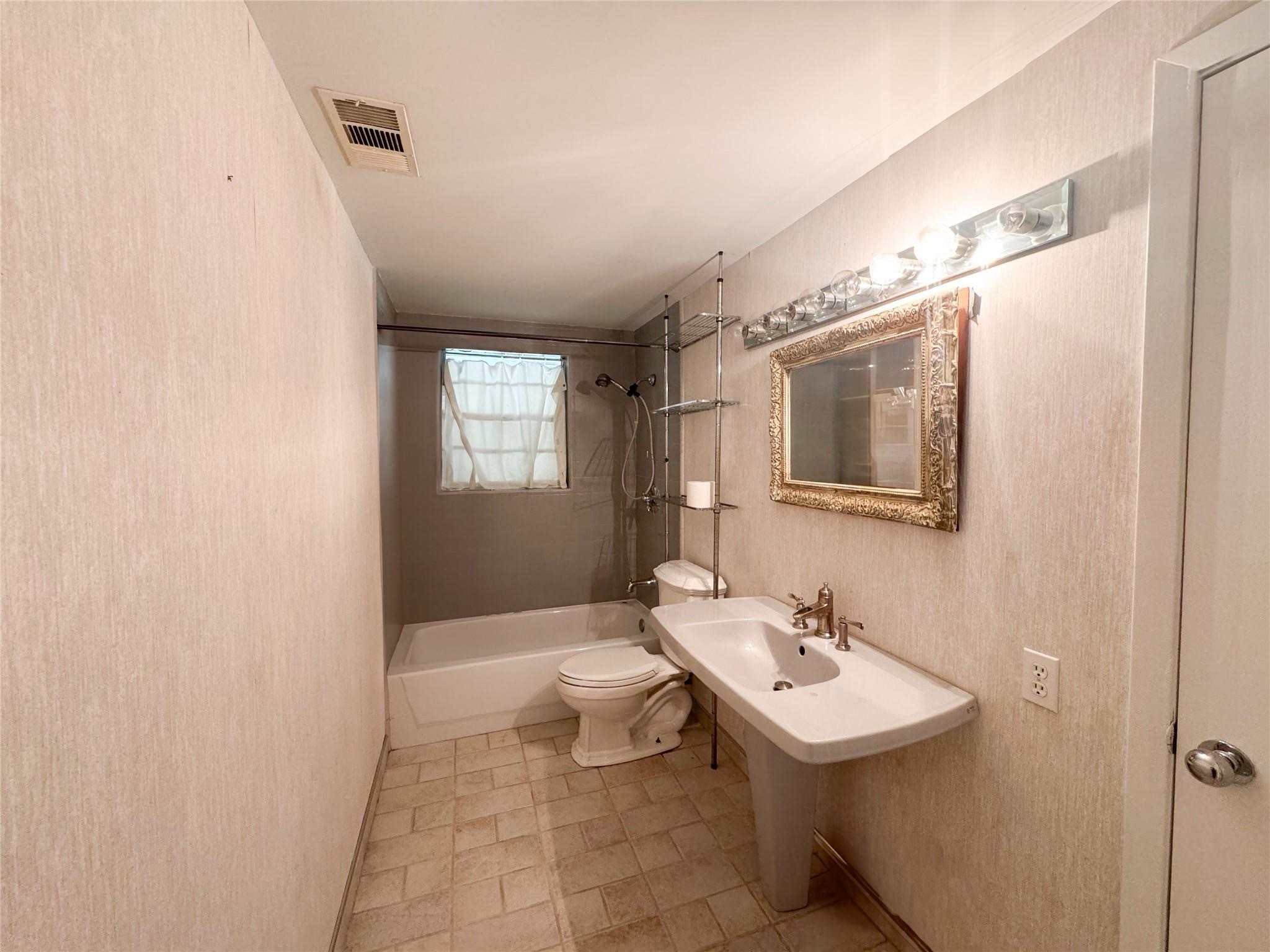 15331 Lake Lamond Road Conroe, TX 77384 - Photo 20 of 29 a bathroom with a sink a toilet and mirror