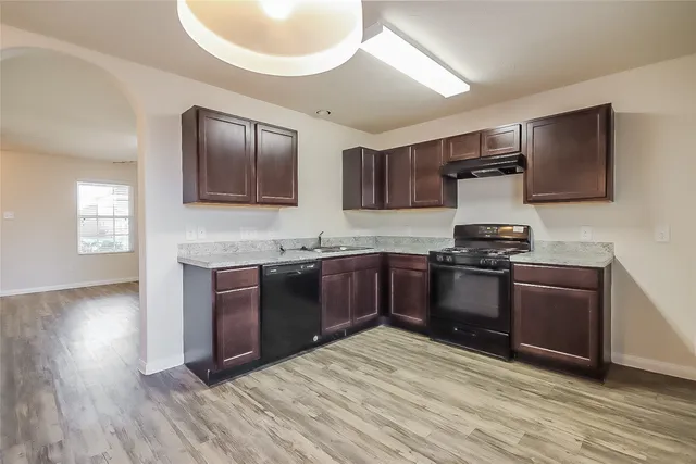 a kitchen with granite countertop stainless steel appliances and wooden cabinets