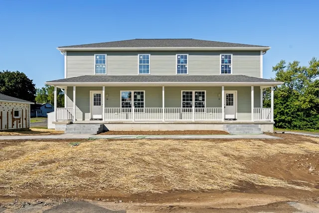 a view of a white house with swimming pool in front of it